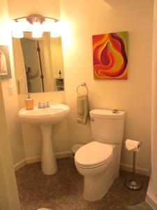 a bathroom with a toilet and a sink at Gardenside Bed and Breakfast in Anchorage