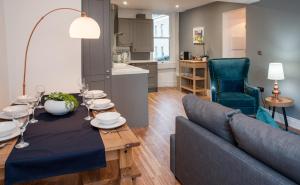 a living room with a table and a couch at MyCityHaven Boutique Luxury in Bath City Centre in Bath +22 photos