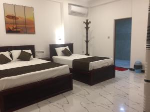 Ένα ή περισσότερα κρεβάτια σε δωμάτιο στο Blue Wings Beach Hotel