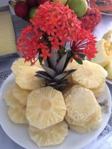 a plate with a bunch of sliced bananas and flowers at Pousada Farol do Porto in Porto De Galinhas +41 photos