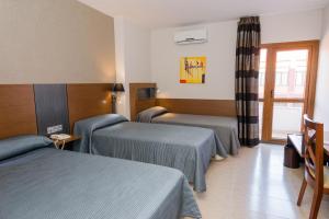 Postel nebo postele na pokoji v ubytování Hotel Regio Cádiz