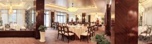 a dining room with a table and chairs in it at Hangzhou Rose Garden Resort & Spa in Hangzhou