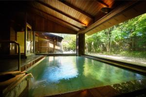 a swimming pool in the middle of a house at Saryo Souen in Sendai