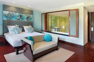 a living room filled with furniture and a large window at Novotel Bali Nusa Dua in Nusa Dua