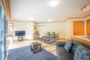 a living room with a couch and a table at Coronation Lodge in Queenstown