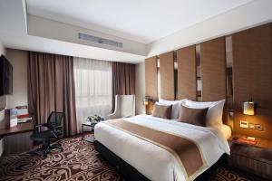 Ein Bett oder Betten in einem Zimmer der Unterkunft Swiss-Belinn Karawang