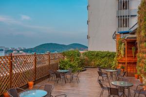 a patio with tables and chairs on a balcony at Metropolo Jinjiang Xuzhou Railway Station Suning Plaza Chudu in Xuzhou