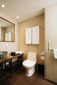 a bathroom with a toilet and a sink at Butterfly on Wellington, Central in Hong Kong