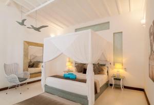 A bed or beds in a room at De'Coco Villa and Suites