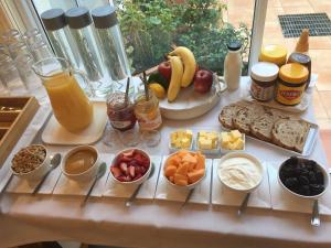 a table with a bunch of different types of food at Bundanoon Lodge in Bundanoon