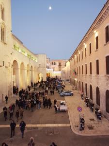 a group of people walking through an alley at Michelle Apartment in Bari