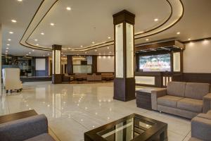 a lobby with couches and a tv in a building at Hotel The Royal Krishna in Katra