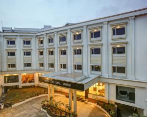 a large white building with a sign in front of it at Hotel The Royal Krishna in Katra