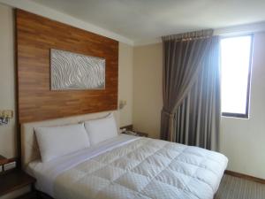 Voodi või voodid majutusasutuse Fu Kuang Hotel toas