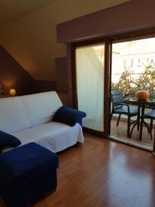 
a living room with a couch and a table at Aramis House Citycentre - con parcheggio Gratis - with Free parking - zona Navigli -Bocconi in Milan
