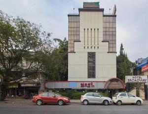 a group of cars parked in front of a building at Yogi Broadway in Mumbai