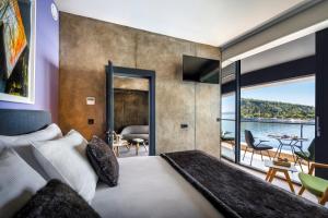 a bedroom with a bed and a view of the water at Boutique & Design Hotel Navis - Small Luxury Hotels of the World in Opatija
