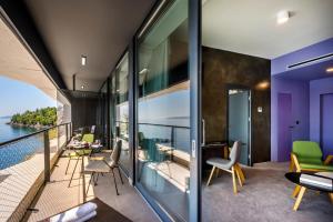 an apartment with a balcony with a view of the ocean at Boutique & Design Hotel Navis - Small Luxury Hotels of the World in Opatija