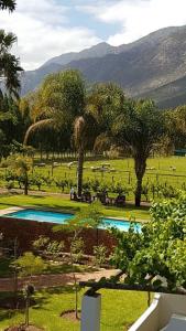 a resort with two swimming pools in a field at Long Acres Cottages in Montagu