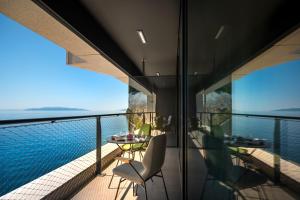 a view from the balcony of a house with a pool at Boutique & Design Hotel Navis - Small Luxury Hotels of the World in Opatija