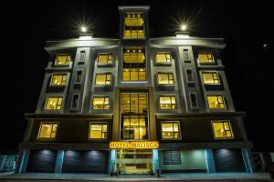 a building with lights on top of it at night at Hotel Malisca in Siliguri