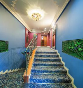 
a hallway with stairs leading up to a staircase at Nikola House in Nizhny Novgorod
