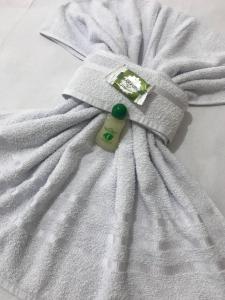 a white blanket with a bottle on top of it at Pousada Vó Dena in Penha +104 photos