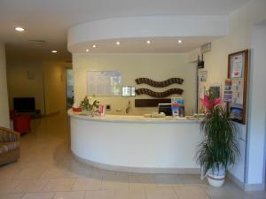 a lobby of a pharmacy with a reception counter at Hotel Tenda Rossa in Marina di Carrara