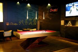 a room with a pool table and a tv at Grand Excelsior Hotel - Bur Dubai in Dubai