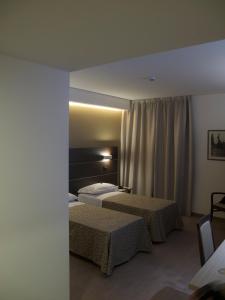 Кровать или кровати в номере Hotel La Conchiglia