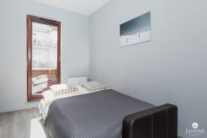 Posteľ alebo postele v izbe v ubytovaní Jantar Apartamenty Lighthouse Port Kołobrzeg