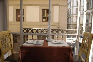 a table on a balcony with a table cloth and napkins at Hotel Medici in Florence
