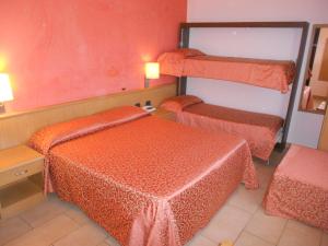 Postel nebo postele na pokoji v ubytování Hotel Tenda Rossa