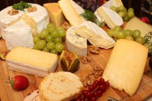 a bunch of cheese and fruit on a cutting board at BG Nautico Ebeso in Ibiza Town