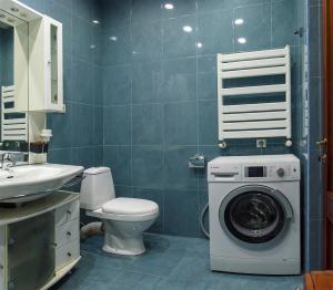 a bathroom with a washing machine and a toilet at Lagidze Apartment in Tbilisi City