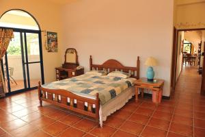 a bedroom with a bed and a table with a lamp at Tuscany Garden B&B in Guanxi