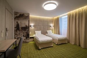 Postel nebo postele na pokoji v ubytování Citi Hotel's Wrocław