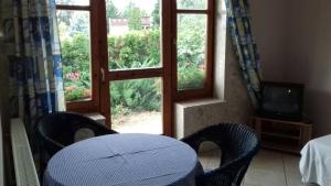 a room with two chairs and a television and a window at Palatinus Apartmanok in Keszthely