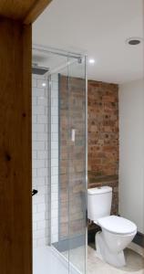 a bathroom with a toilet and a glass shower at Drovers Rest in Hay-on-Wye