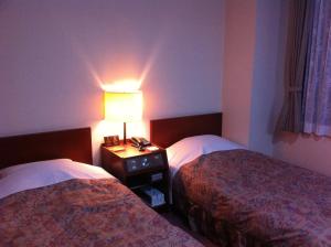 Ένα ή περισσότερα κρεβάτια σε δωμάτιο στο New Furano Hotel