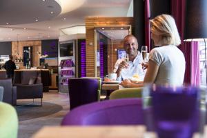 a man and a woman sitting at a table in a restaurant at Anthony's Life&Style Hotel in Sankt Anton am Arlberg +37 photos