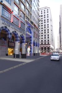 a car driving down a street in front of a building at LEADER Al Muna Kareem Hotel in Al Madinah