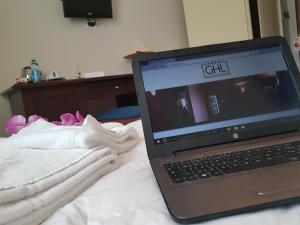 a laptop computer sitting on top of a bed at Grand Hotel Lamezia in Lamezia Terme
