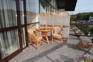 a patio with a table and chairs on a balcony at Lavina Hotel in Dnipro