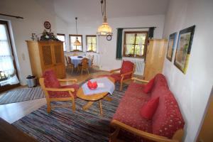 a living room with a couch and chairs and a table at Carina, Martin, Michael & Sissi in Garmisch-Partenkirchen