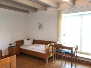 a bedroom with a bed and a desk and a table at Schloss Beuggen in Rheinfelden