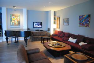 a living room with a piano and a couch at Leonidionhouses - The Ogra House in Leonidion
