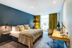 a bedroom with a large bed and a large window at Apex City of Bath Hotel in Bath