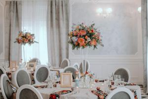 a banquet room with white tables with flowers on them at Pałac Lacon in Kazimierza Wielka