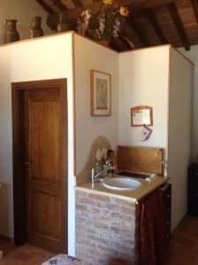 a bathroom with a sink in a room at Agriturismo La Collina in Siena